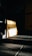 A dimly lit gym environment with a focus on a wooden panel displaying 'Muscle Up Performance'. Shadows and light create a dramatic effect on the dark-tiled floor. Motivational words like 'Focus', 'Motivation', 'Dedication', and 'Excuses' are subtly visible on the wall.