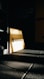 A dimly lit gym environment with a focus on a wooden panel displaying 'Muscle Up Performance'. Shadows and light create a dramatic effect on the dark-tiled floor. Motivational words like 'Focus', 'Motivation', 'Dedication', and 'Excuses' are subtly visible on the wall.