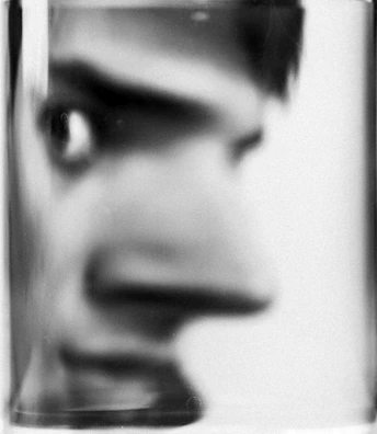 Close-up of a pixel art original featuring a minimalist black-and-white surreal face.