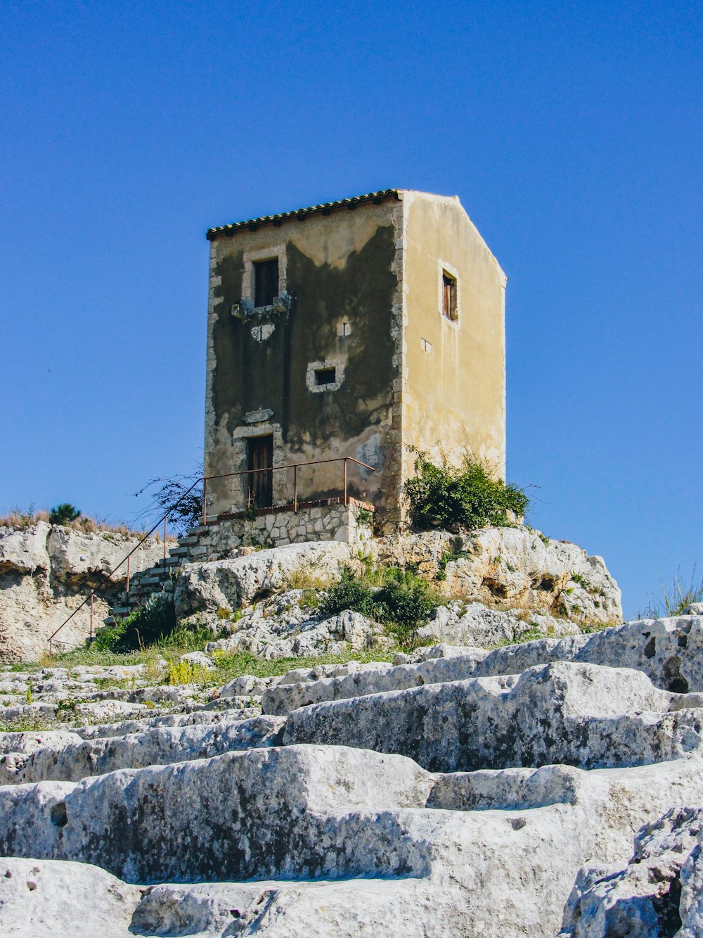 a stone building on a hill