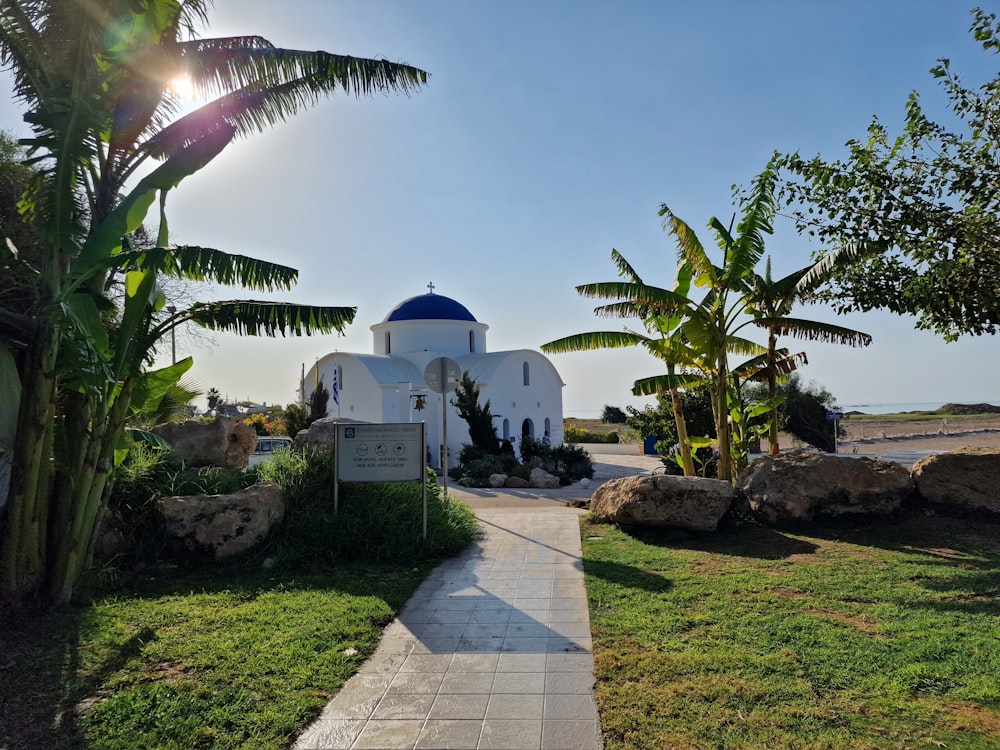 a path leading to a white building