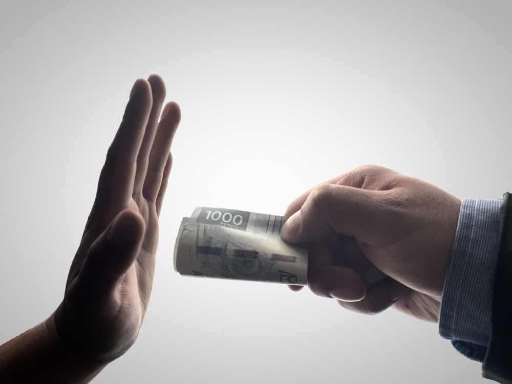 a person holding a stack of cash