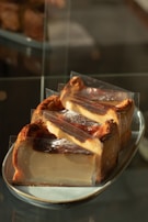 Slice of creamy and rich homemade torta with a golden crust on a white plate.