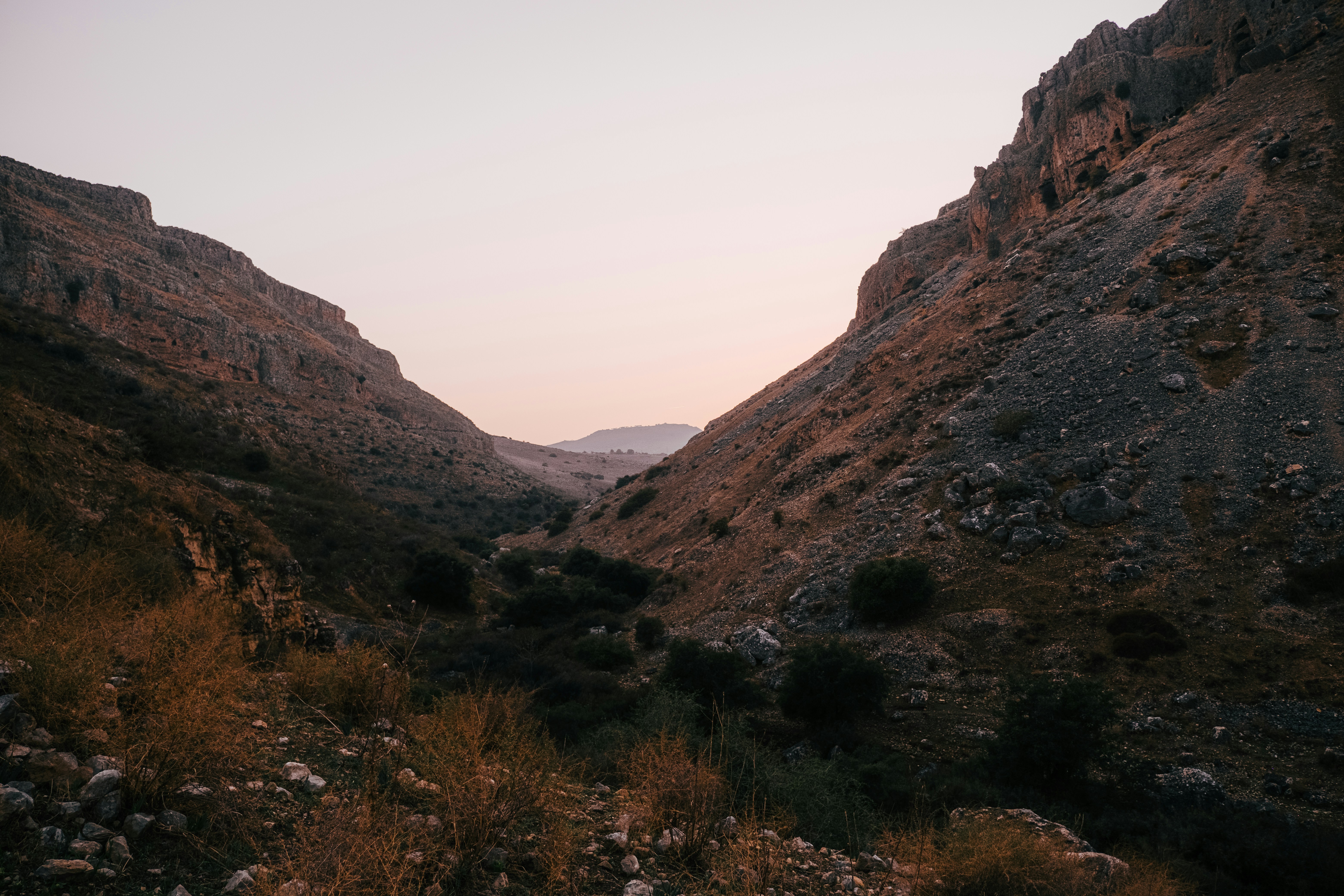 a rocky canyon with a valley