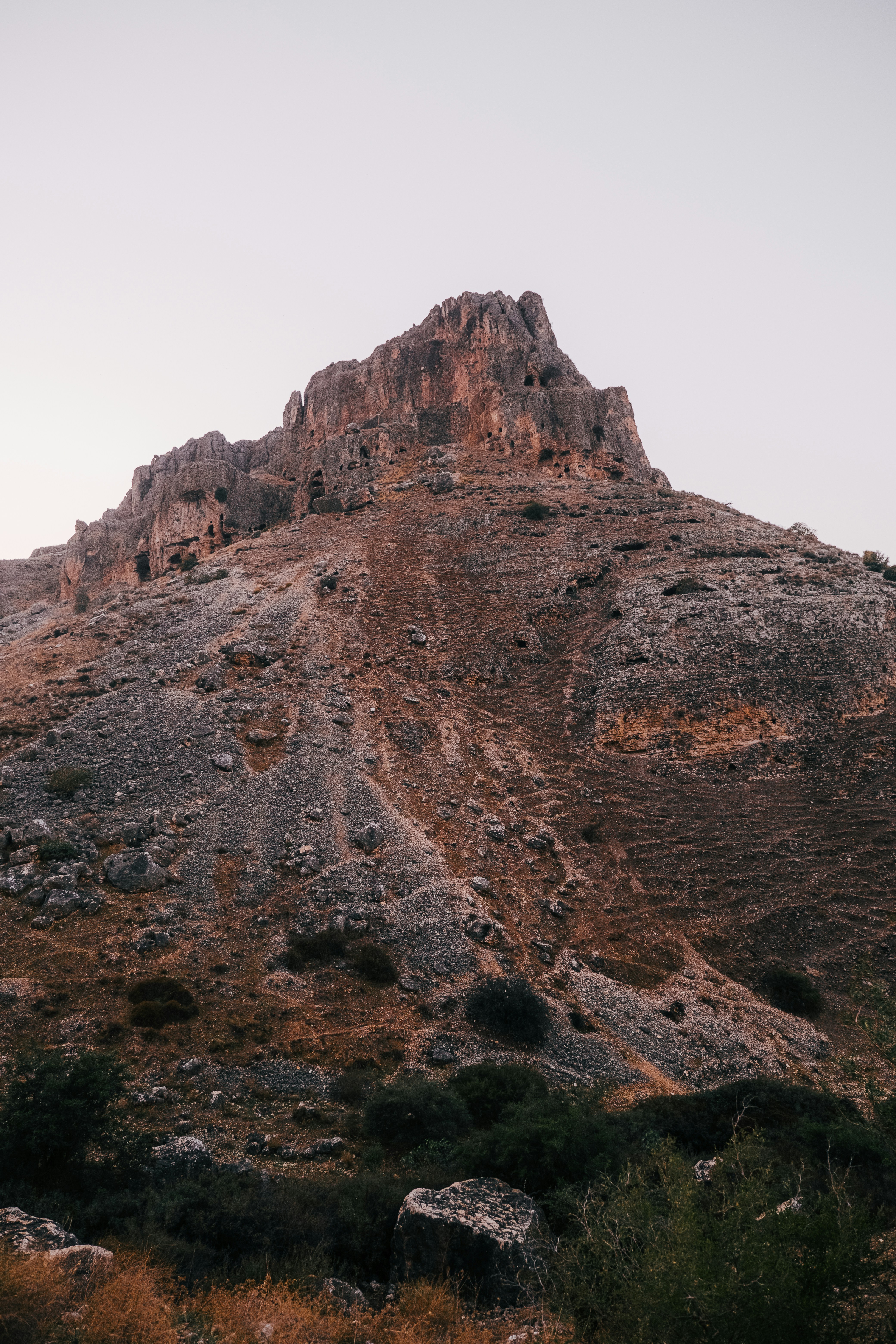 a rocky mountain with a valley below