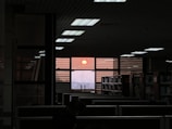 An inspiring shot of a sunset viewed through the office window, symbolizing new ideas.