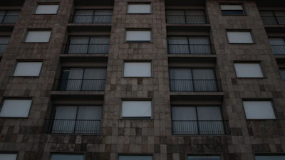 Facade of a brick building featuring sturdy steel window guard rails blending security and design.