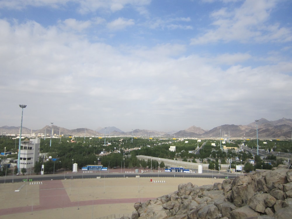 a parking lot with a bus and buildings in the background