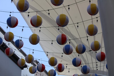 Playful moment capturing colorful balls bouncing on top of the 3-meter parachute fabric.