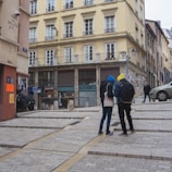 Men and women posing in colorful urban jackets and hoodies on the street.