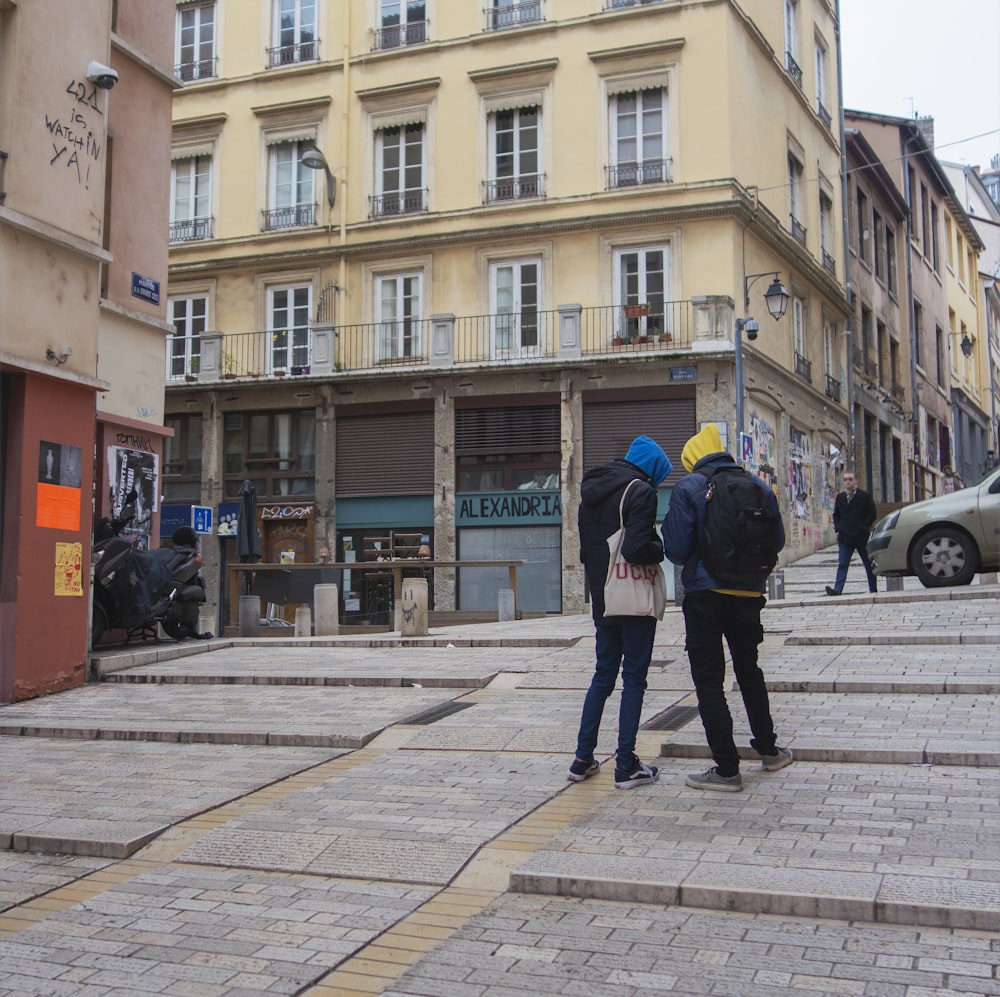 a group of people standing on a street corner