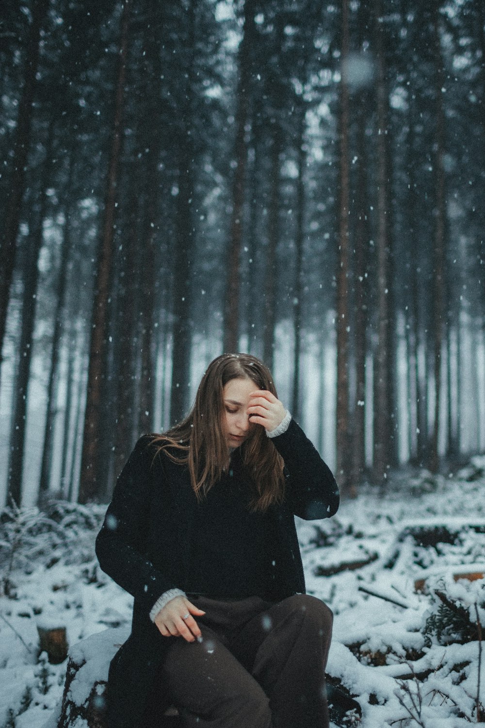 a woman sitting in the snow