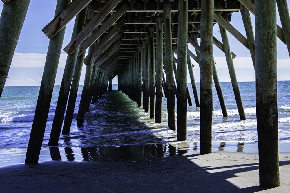 a long pier stretches out into the ocean