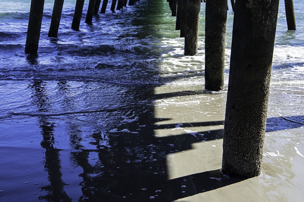 a view of the ocean from underneath a pier