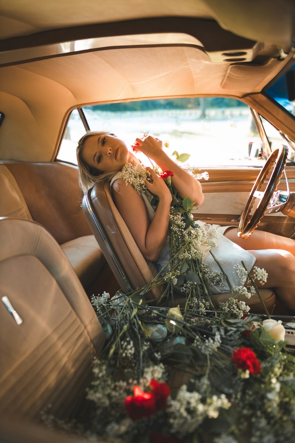 a woman sitting in the back seat of a car