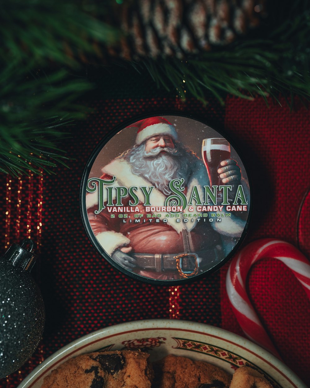 a plate of chocolate chip cookies next to a christmas ornament