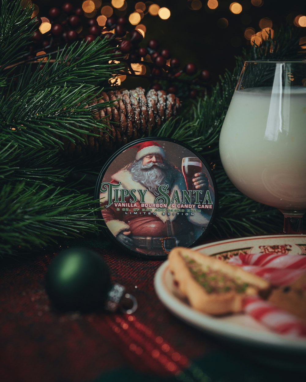 a glass of milk next to a plate of cookies