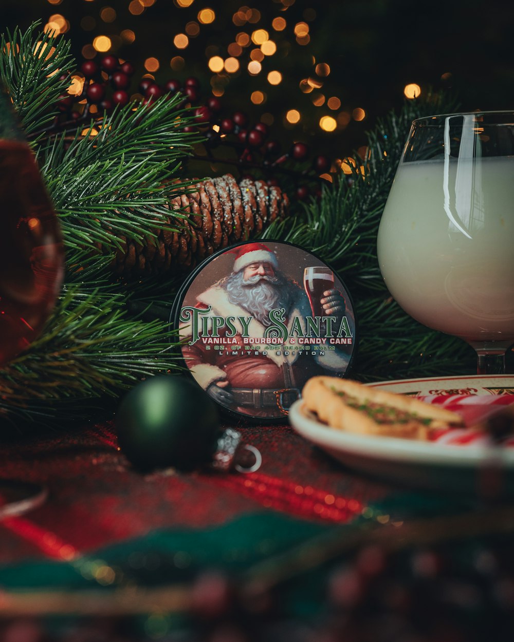 a glass of milk next to a plate of cookies