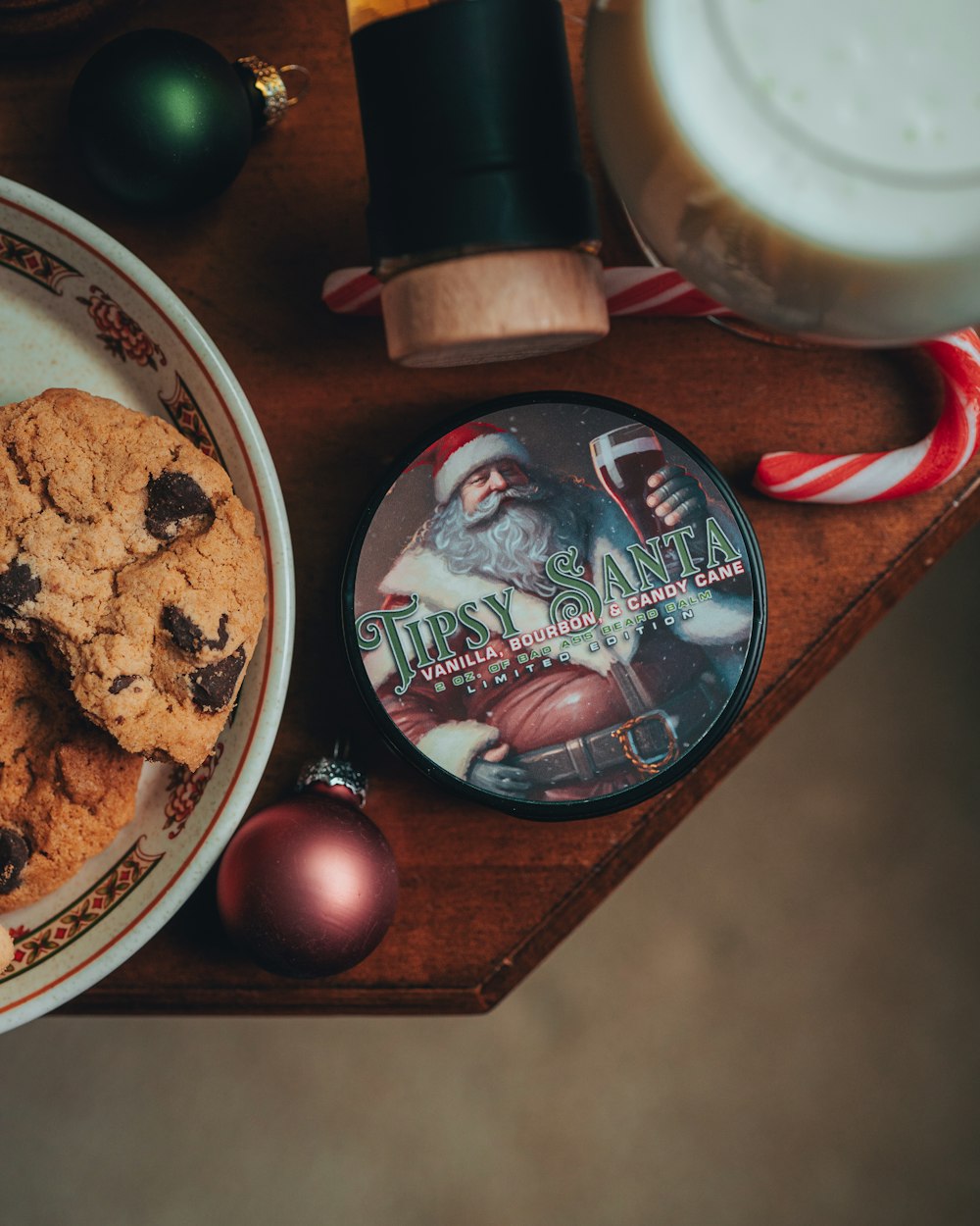 a plate of chocolate chip cookies next to a bowl of candy canes