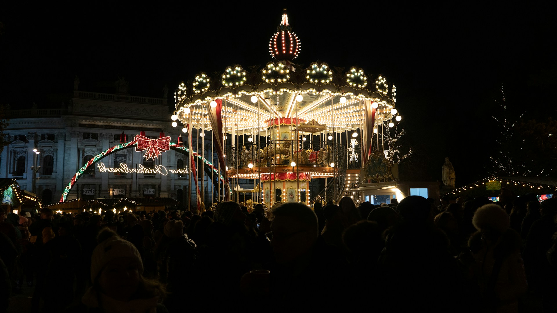 A wide shot of the carousel with people admiring the products, creating a lively atmosphere.