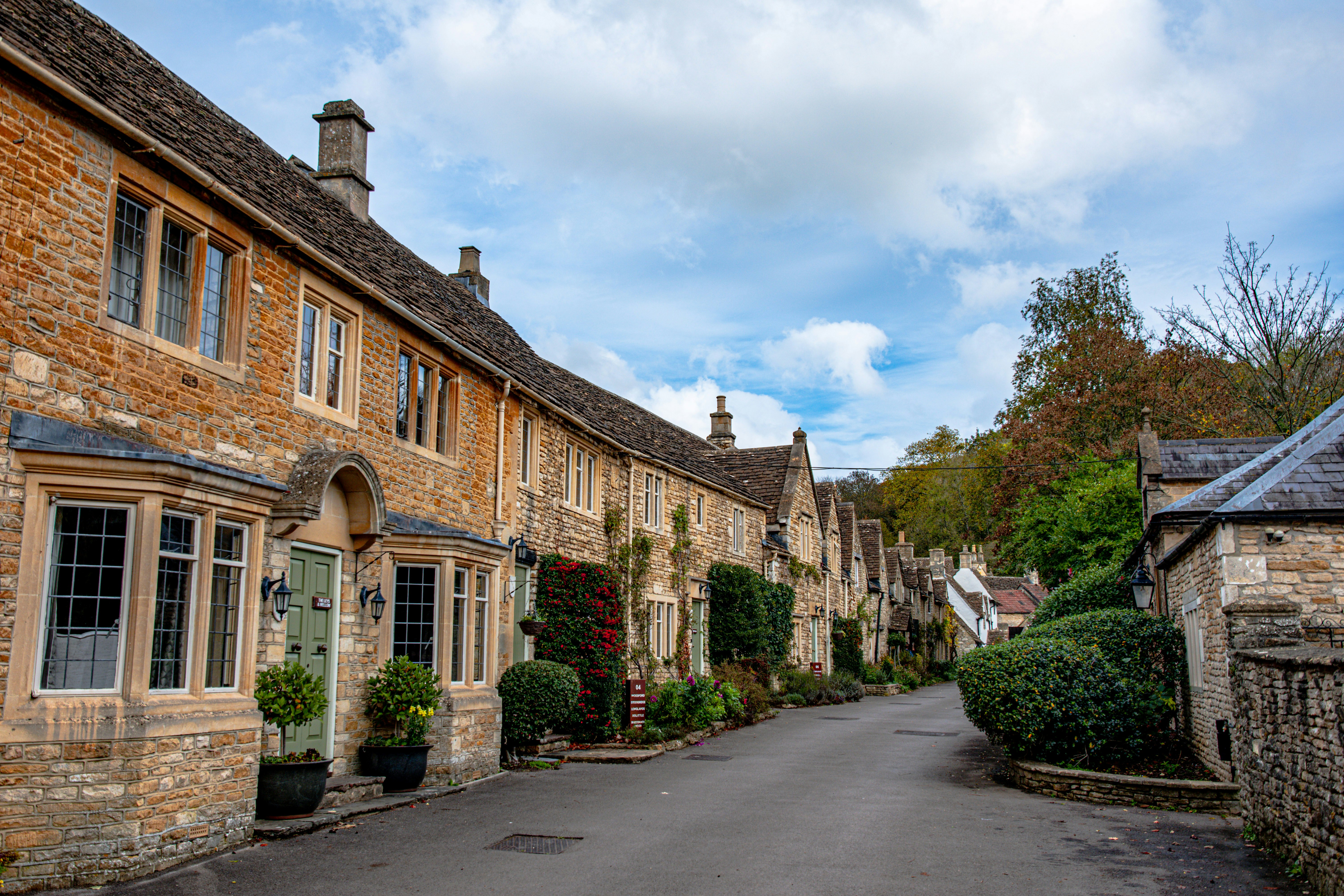 a street lined with stone buildings and trees