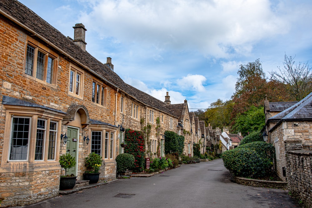 a street lined with stone buildings and trees