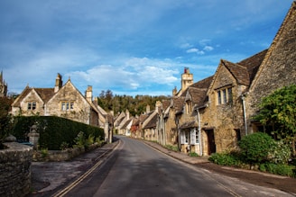 a street lined with old stone houses under a blue sky