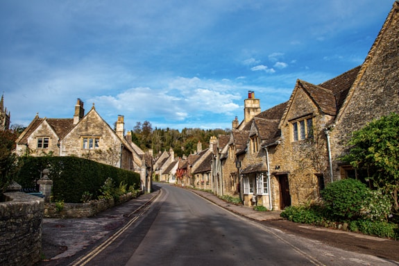 a street lined with old stone houses under a blue sky