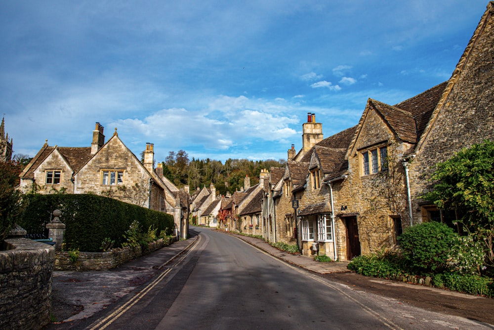 a street lined with old stone houses under a blue sky