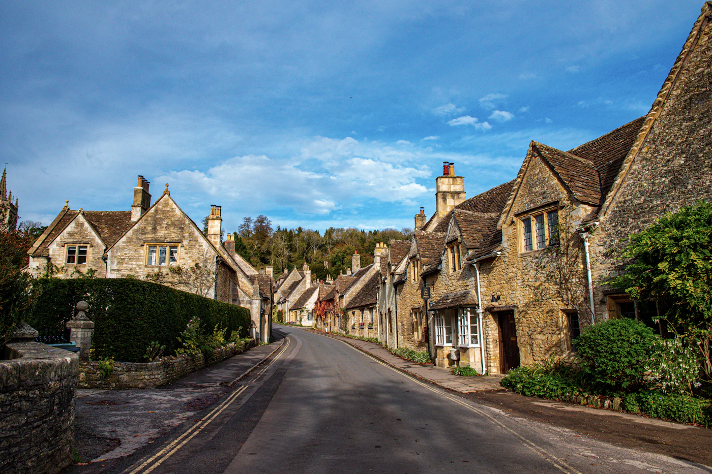 An English market-town high street with stone-fronted independent businesses — the kind of street where a UK business owner actually trades.