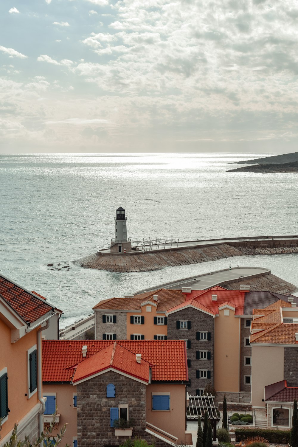 a view of a body of water with a lighthouse in the distance