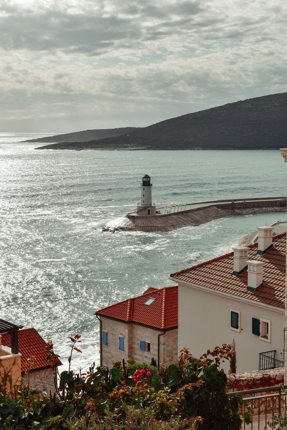 a view of a body of water with a lighthouse in the distance