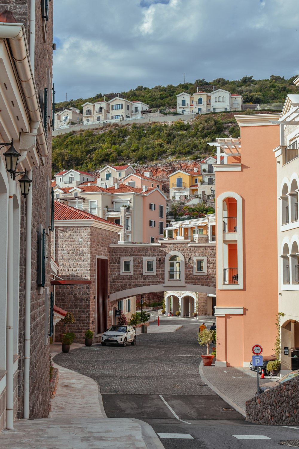 a city street with a hill in the background