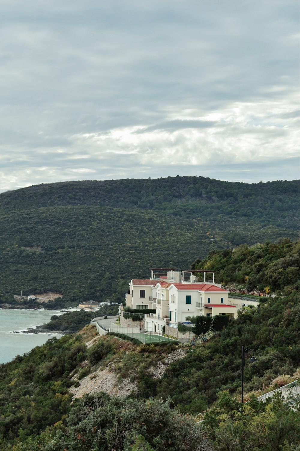 a house on a hill overlooking a body of water