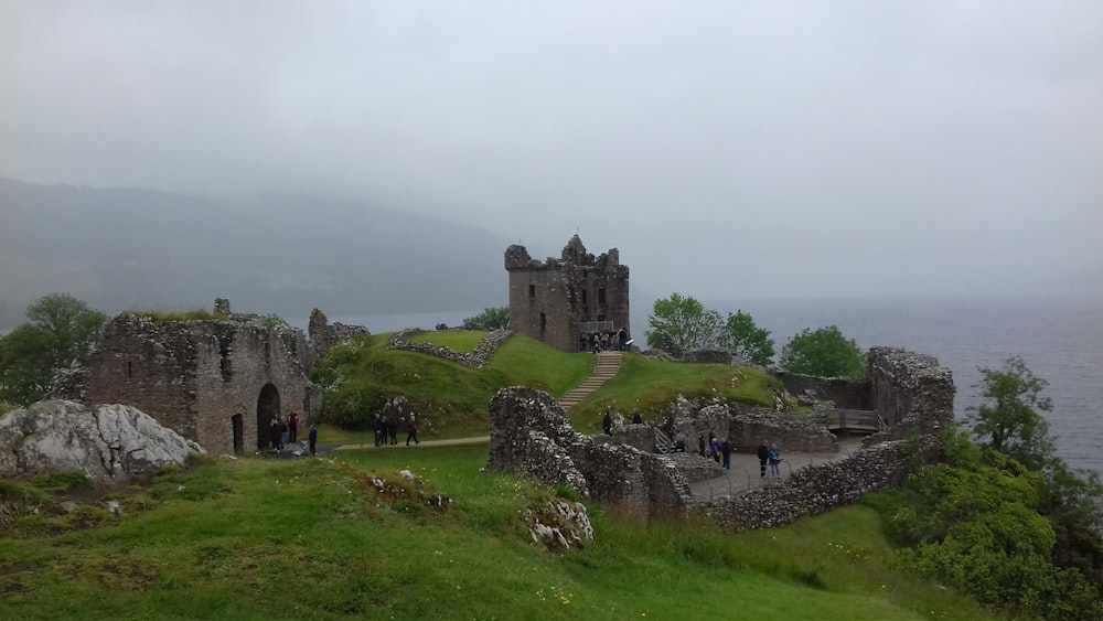 a castle on top of a hill near the ocean