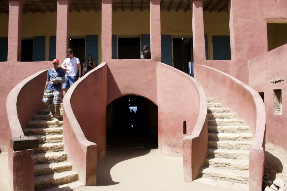 a couple of people that are standing on some stairs