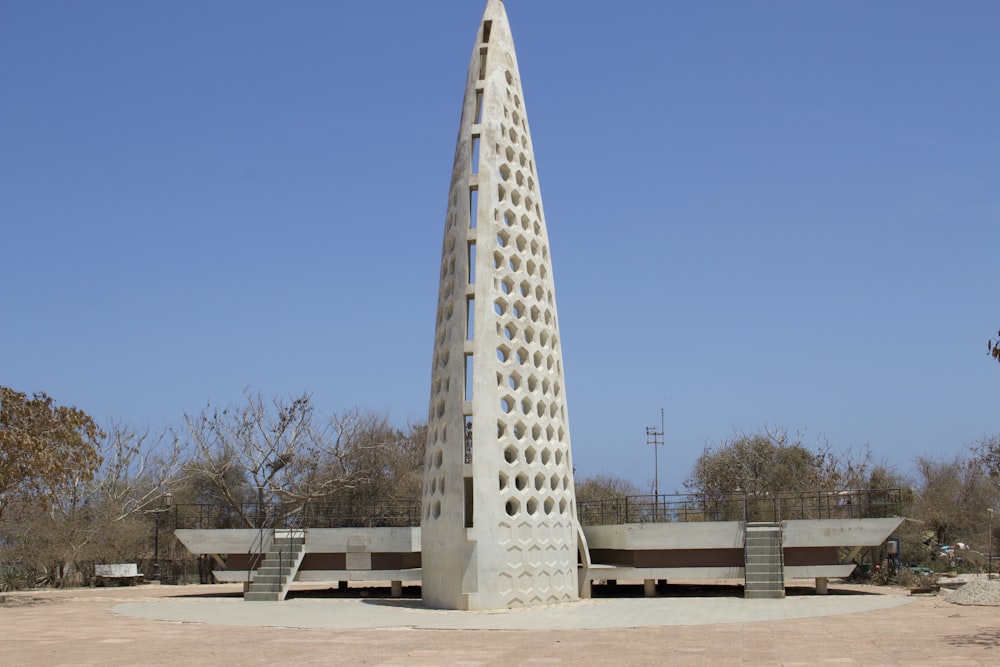 a tall white building sitting in the middle of a desert