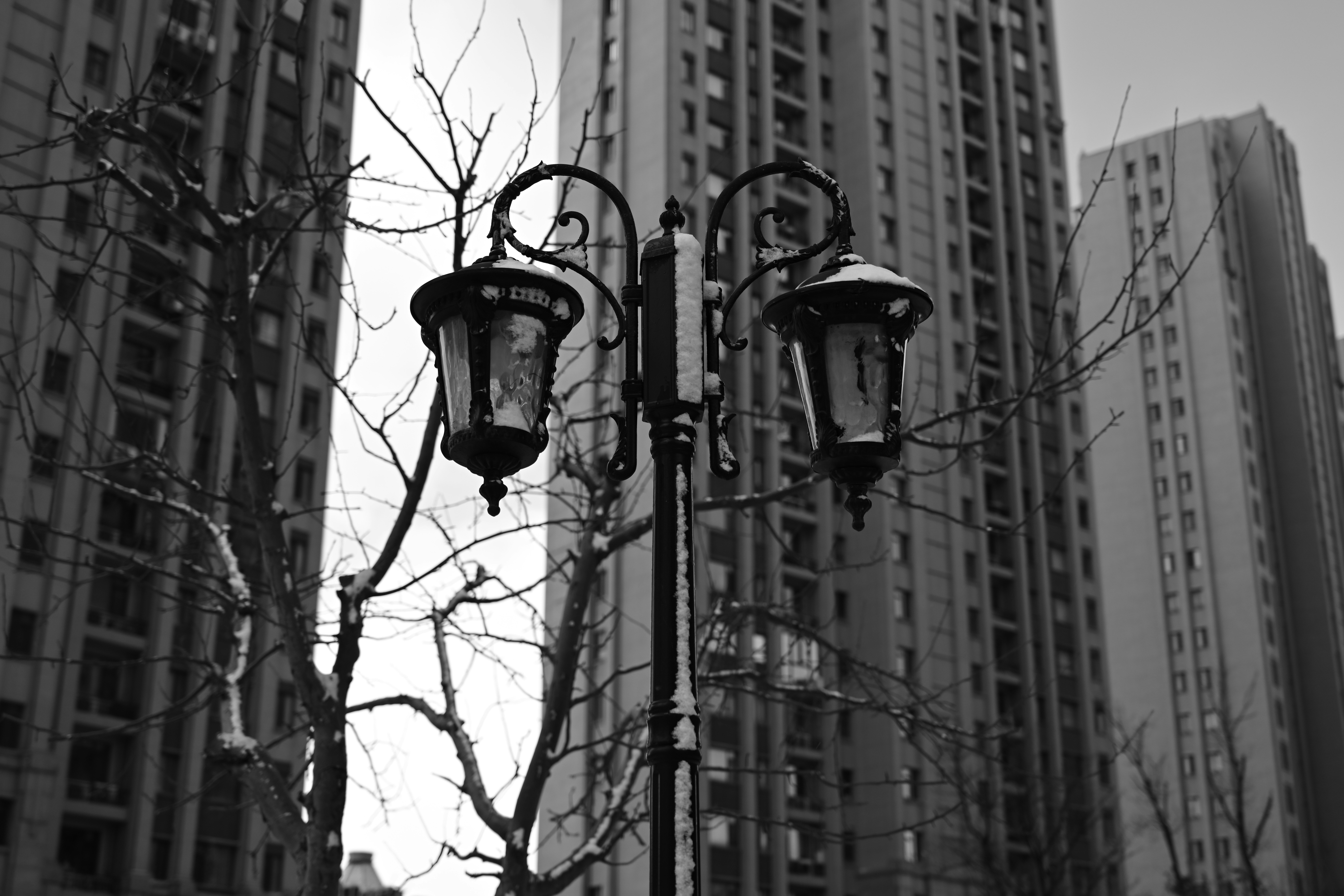 A black and white photo of a street light