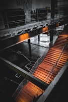 Finished mezzanine floor with black support beams and orange accents under bright lighting.