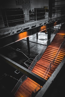 Finished mezzanine floor with black support beams and orange accents under bright lighting.