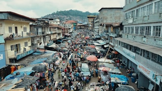 A vibrant street market scene in Lagos bustling with people and colorful stalls.