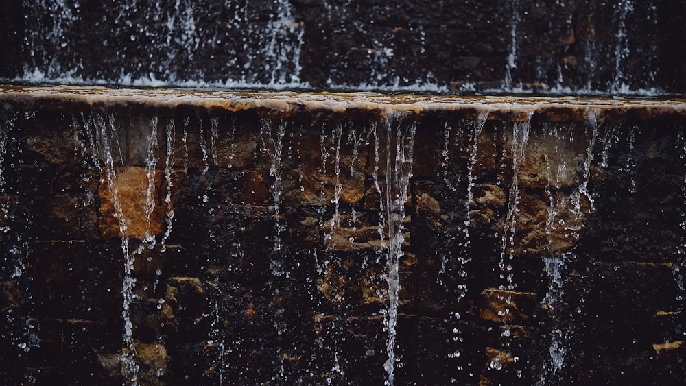 a close up of a waterfall with water running down it