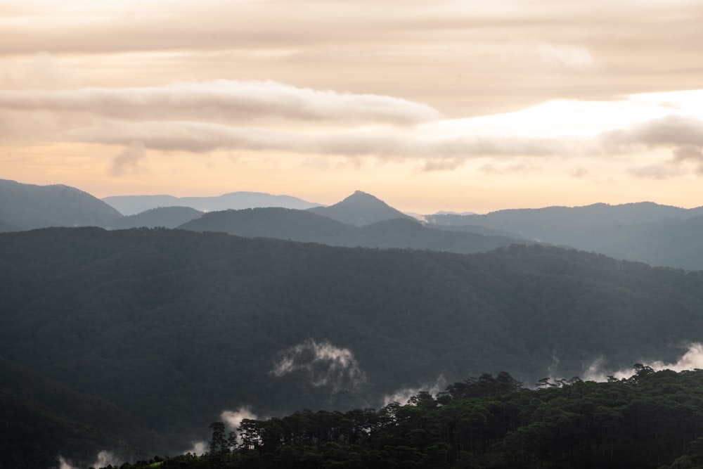 a view of a mountain range covered in mist