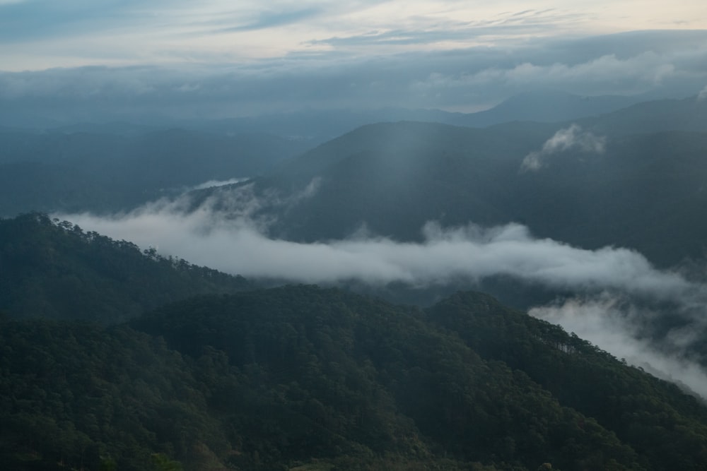 a view of a mountain range covered in clouds