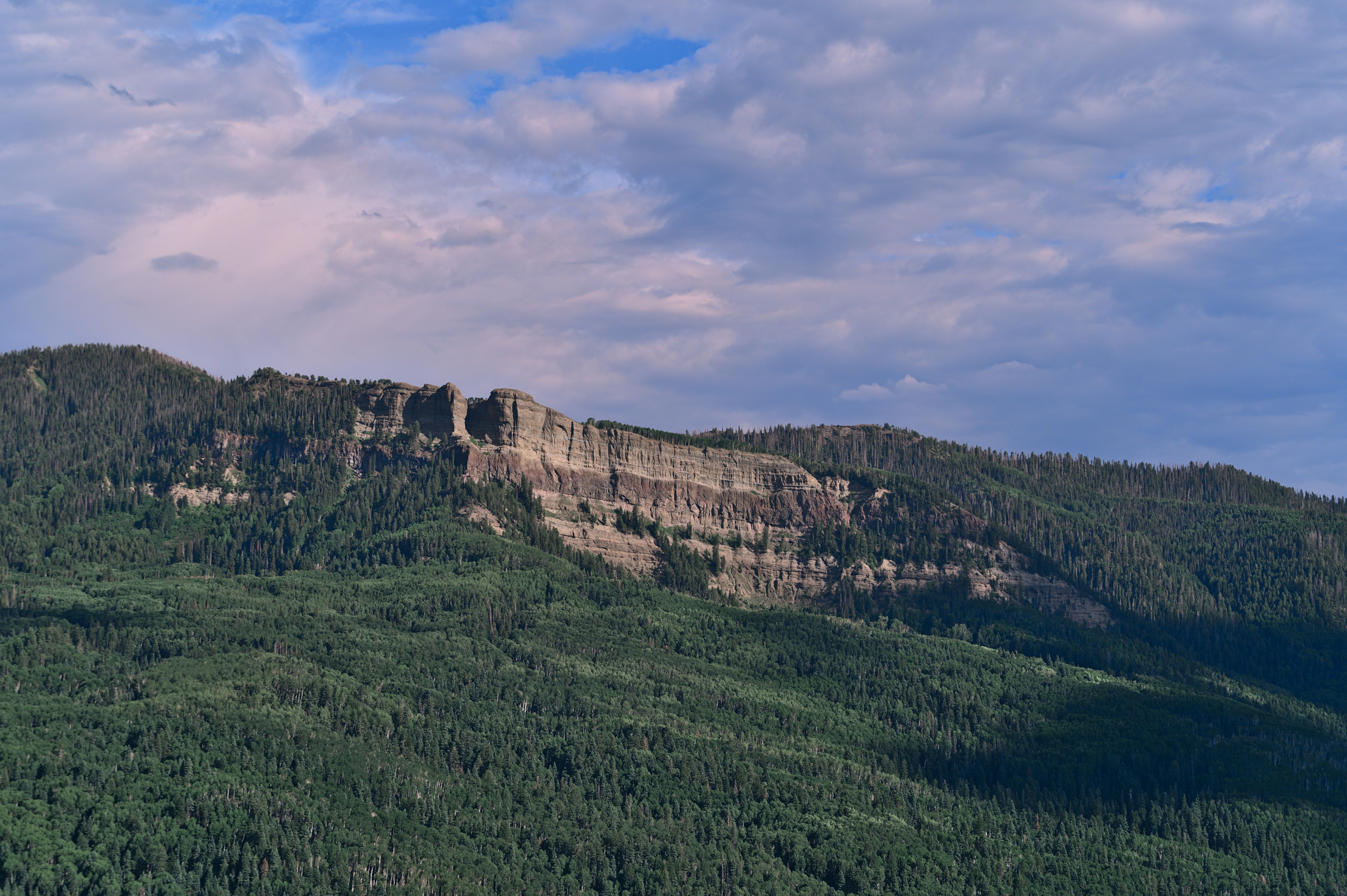 Summer 22, Day 17 - Stopping at Wolf Creek Valley Overlook I took the driving seat from there. After driving for a few hours, I saw this stunning overlook. The overlook was at a high altitude. There was a beautiful valley with camping areas surrounded by mountains.