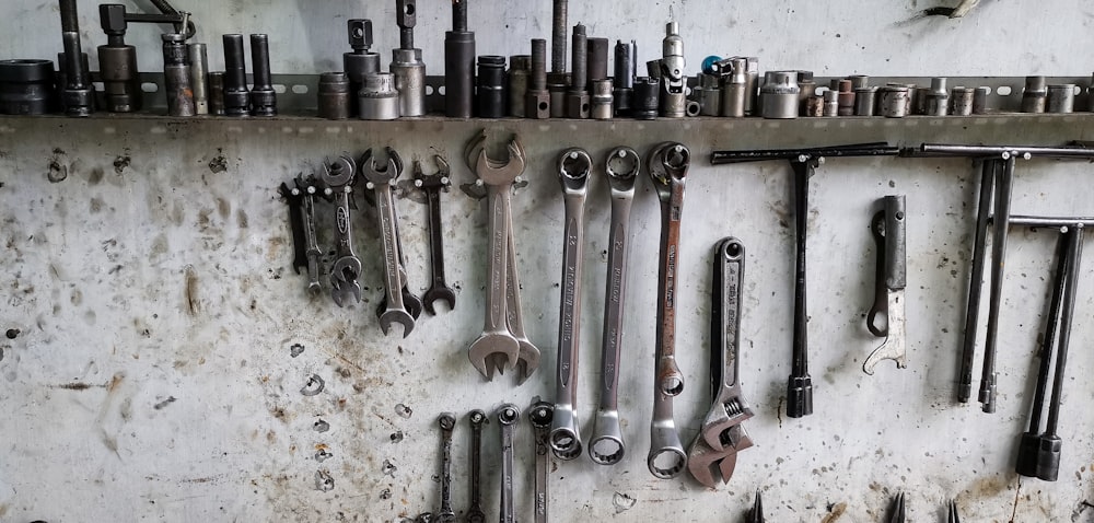 a bunch of wrenches hanging on a wall