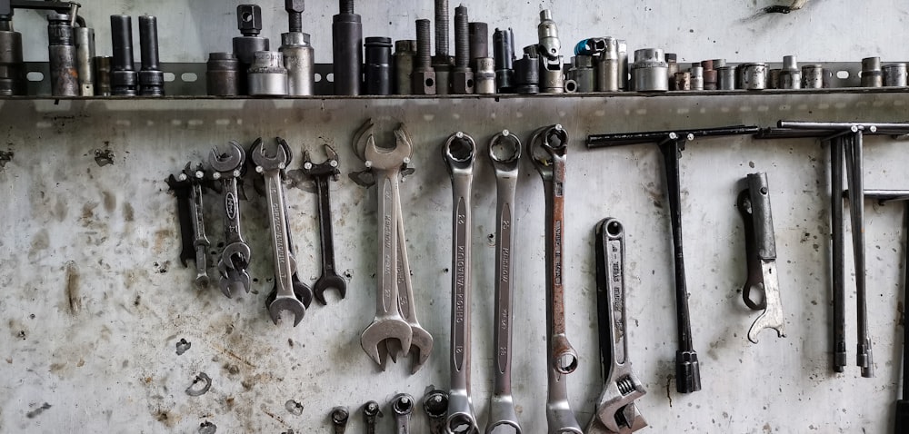 a bunch of tools are hanging on a wall