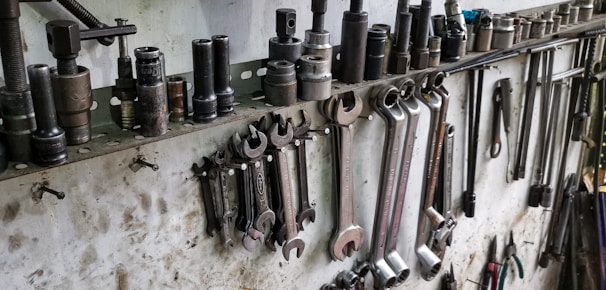 a bunch of tools are hanging on a wall