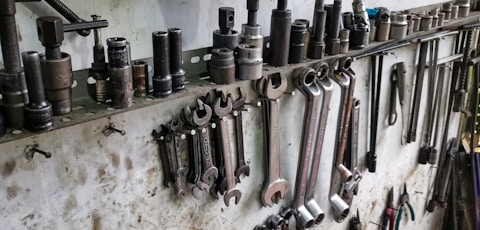 a bunch of tools are hanging on a wall