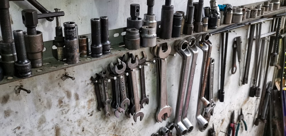 a bunch of tools are hanging on a wall